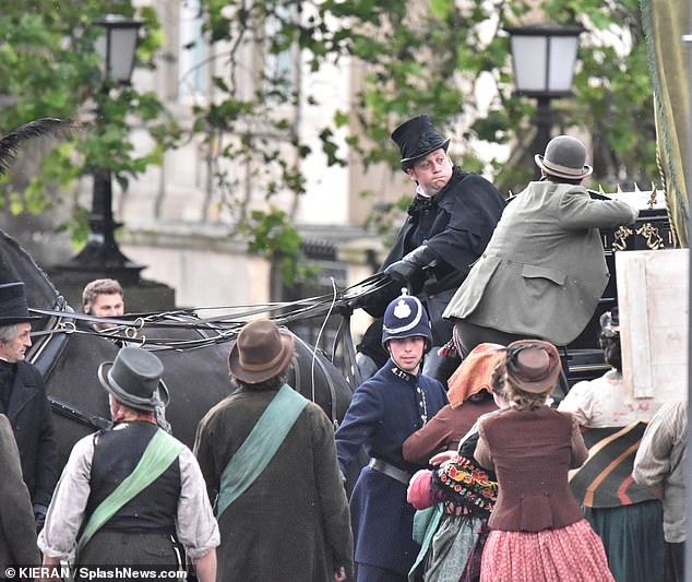 James later climbed into a horse and carriage while several characters stood below shouting at the star.