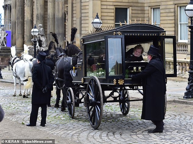 Elsewhere in the scenes, a man was seen lying in a coffin on the back of a horse and carriage.