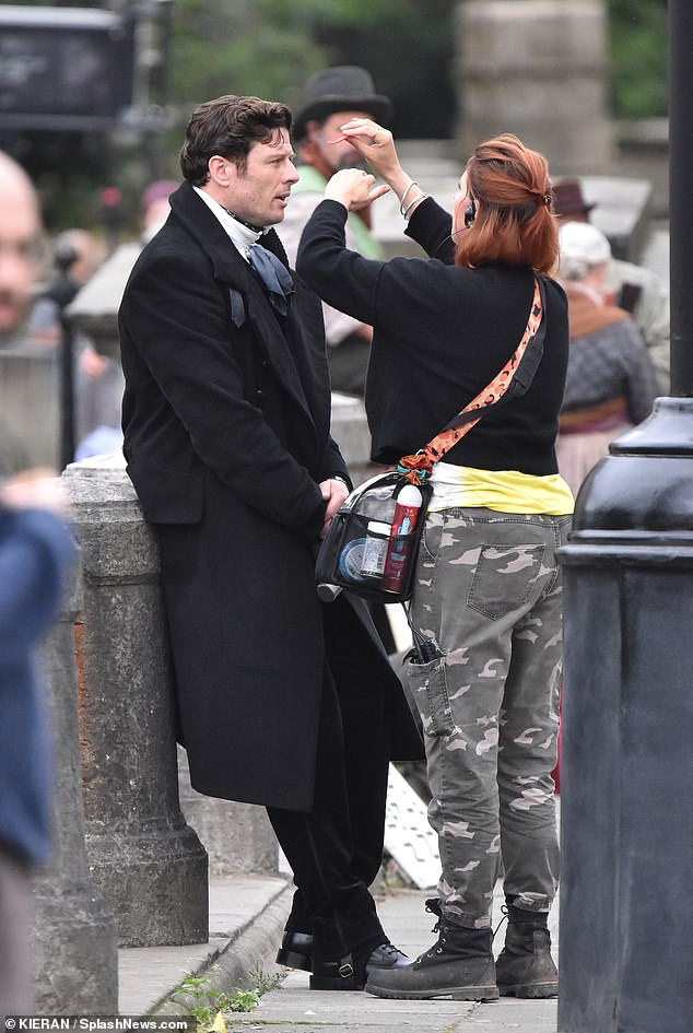 Between scenes, James appeared to be in good spirits as the on-set crew touched up his hair and makeup.