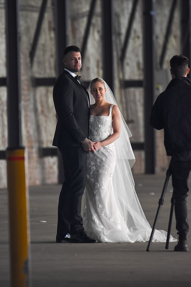 The burly guy looked impressed as he tied the knot with his stunning bride.