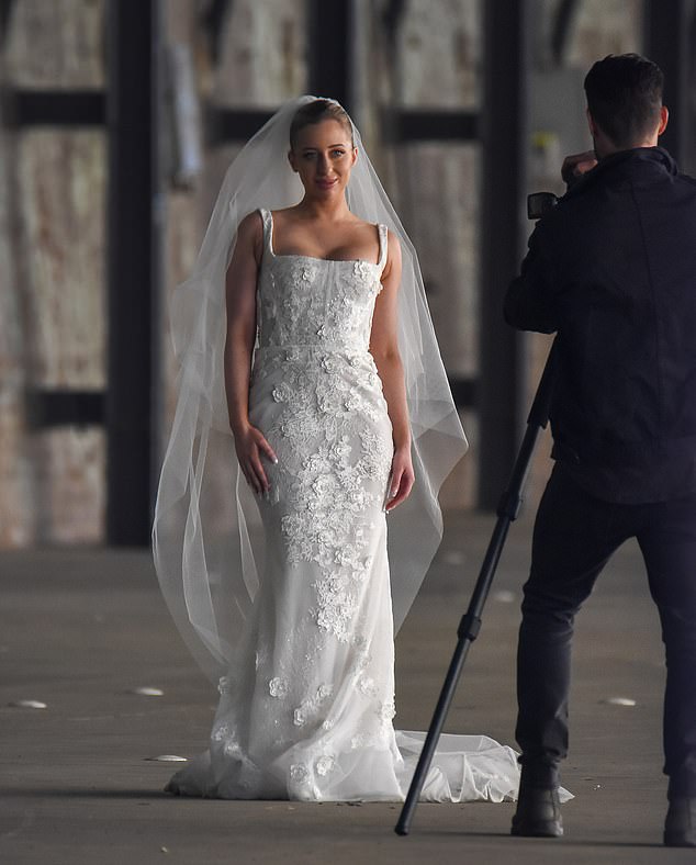 She added a loose veil and opted for a clean bridal makeup look as she swept her hair out of her face.