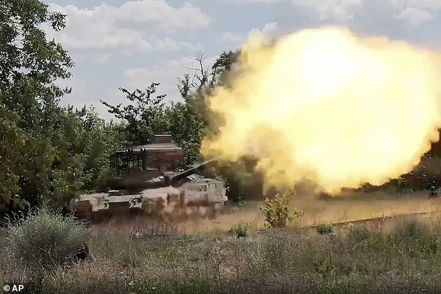 In this image taken from a video released by the Russian Defense Ministry on Tuesday, July 16, 2024, a Russian tank fires towards a Ukrainian position at an undisclosed location.