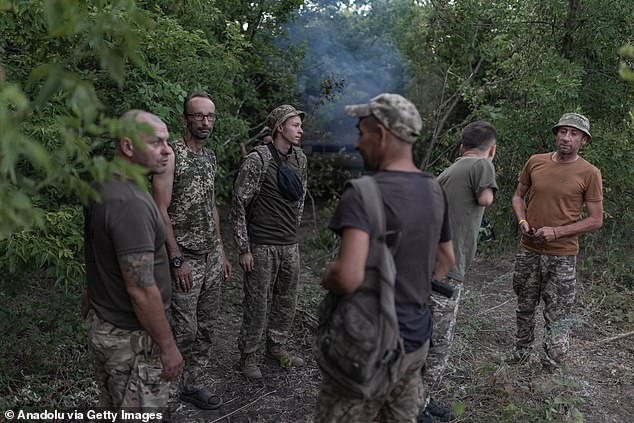 Ukrainian soldiers stand next to a tank in a rear position after attacking Russian positions in Donetsk Oblast, Ukraine, July 20.