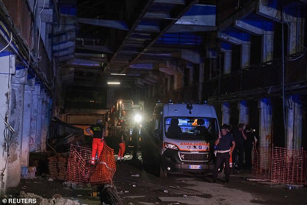 Of the 13 injured, seven are children. Pictured: an ambulance at the site of the collapsed balcony in Naples yesterday