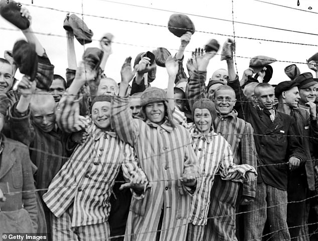 Young prisoners interned at the Dachau concentration camp cheer their liberators, the US Army's 42nd Division.