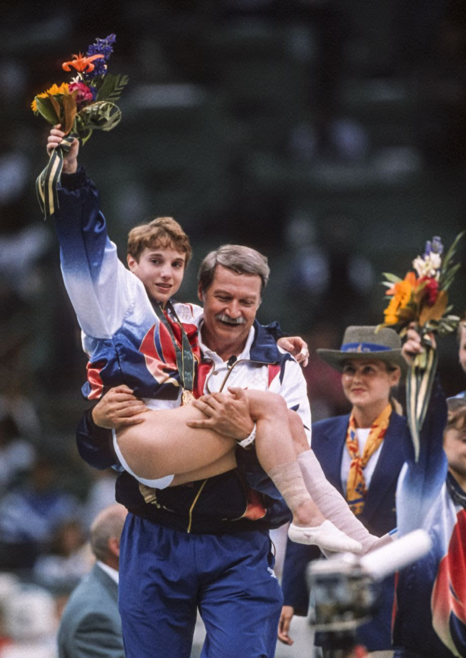 Strug is coached by Béla Károlyi. (David Madison/Getty Images)