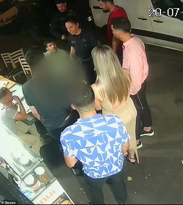 The Australian woman sought refuge inside the Paris kebab shop but was confronted by one of the men who had attacked her minutes earlier. Passers-by are seen talking to the woman, who appears in a blur, and to police.