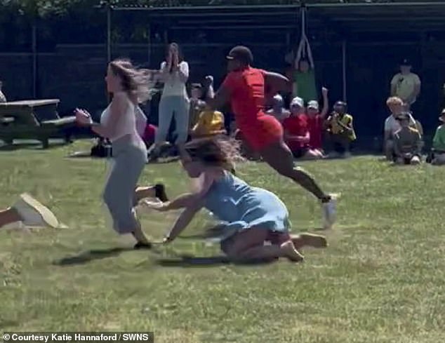 Other parents rushed forward to help the mother of two after she tripped and fell on the grassy track.