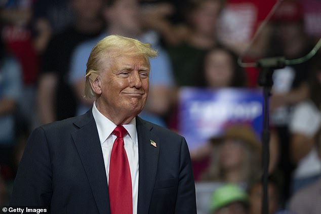 Trump (pictured at a rally in Grand Rapids, Michigan, on Saturday) has a lead of at least 2 points over Harris and as much as 9 percent.