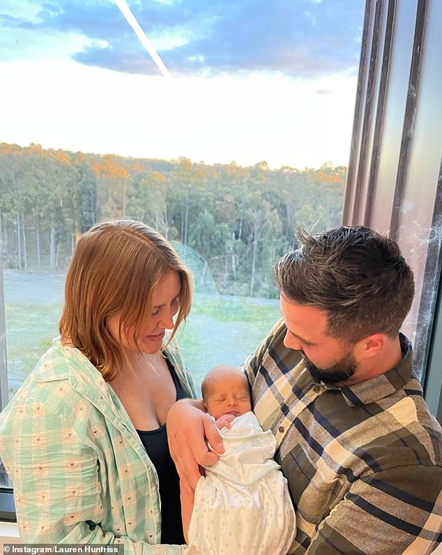 Another photo showed Lauren and Wade as doting parents, both holding Henry between them.