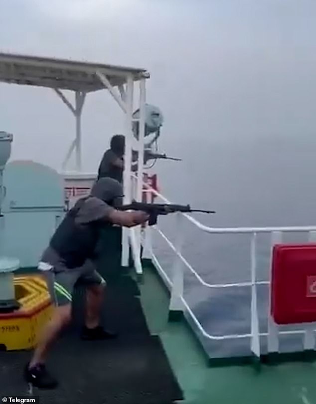 Crew members aboard the container ship open fire on the small vessel before it explodes.