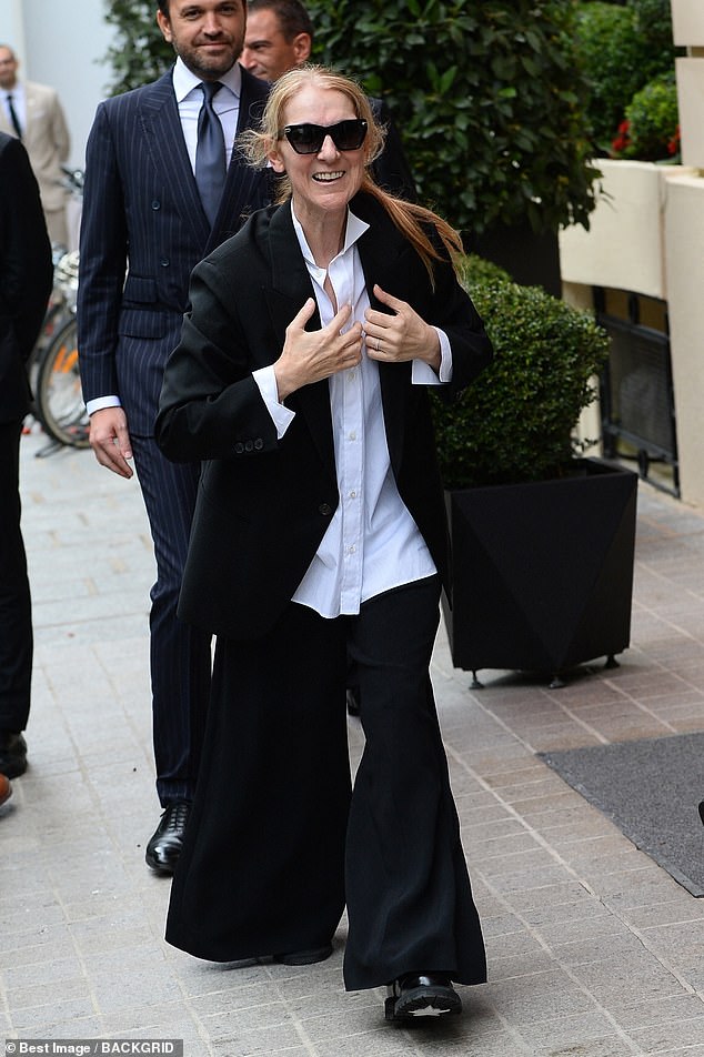 Céline appeared in high spirits as she arrived at her hotel in Paris on Tuesday ahead of the Olympics.