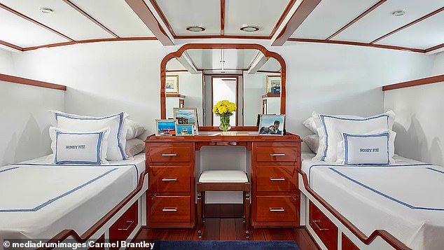 In one of the guest cabins, there are framed photographs of the Kennedy family enjoying life at sea on the ship.