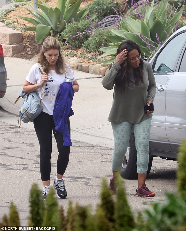 She paired it with light green cropped leggings with an embossed pattern, which she contrasted with a sleek pair of burgundy Adidas Ultraboost sneakers from Beyoncé's Ivy Park collection.