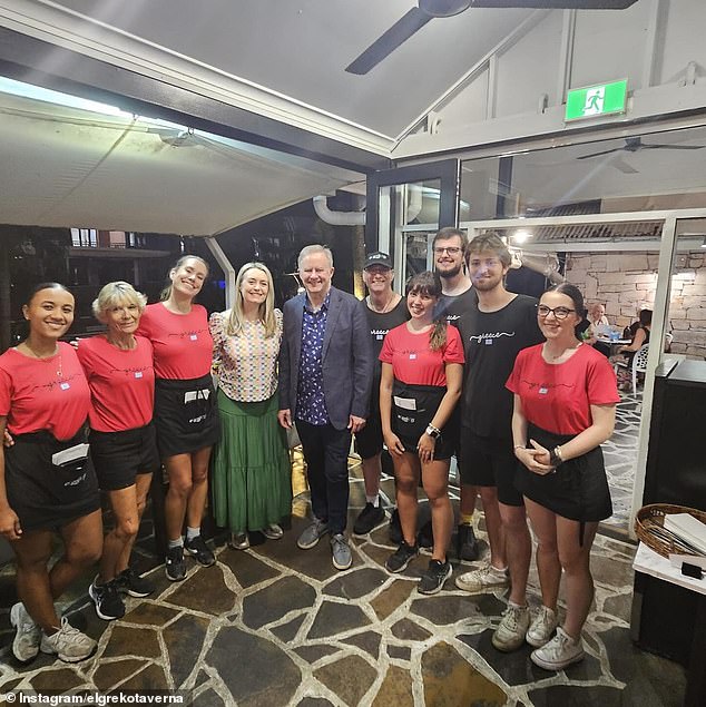 Mr Albanese and Mrs Haydon pose with waiters after a quiet Christmas dinner at Greek taverna El Greko