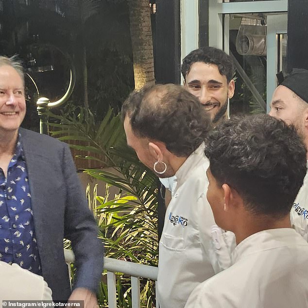 Mr Albanese (pictured left) has a laugh on Saturday night with some of the kitchen staff at El Greko.