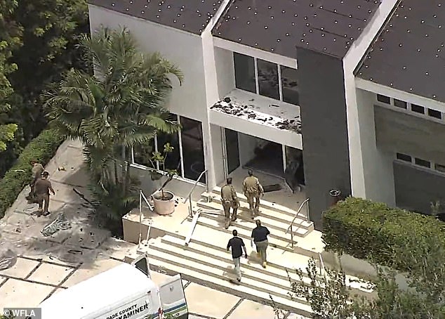 Aerial footage of the aftermath of the raid showed front doors and windows smashed by the SWAT team.