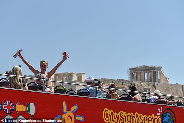 Tourists arrive on top of a bus at the Acropolis as a prolonged heatwave peaks in Athens, July 21, 2024