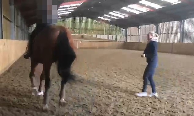 The footage shows her hitting the horse several times with the whip as she tries to teach him the 'piaffe'.