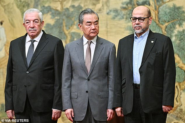 Mahmoud al-Aloul, vice chairman of the Central Committee of the Palestinian political party and organization Fatah, Chinese Foreign Minister Wang Yi and Mussa Abu Marzuk, a senior Hamas member, attend a meeting in Beijing on Tuesday.