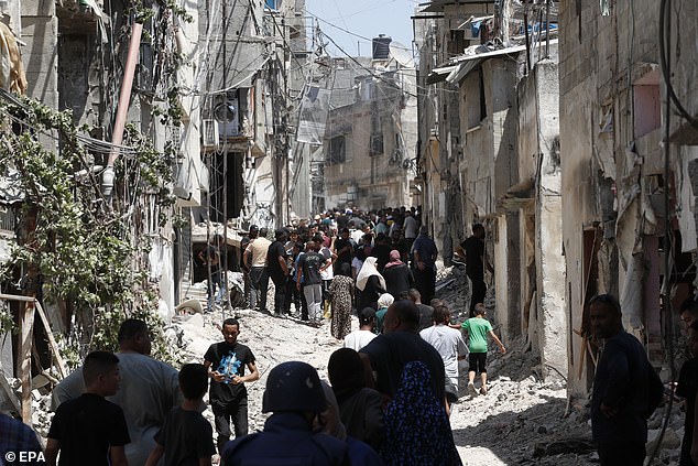 Palestinians inspect the damage caused by an Israeli military operation in the West Bank town of Tulkarem, on July 23, 2024.