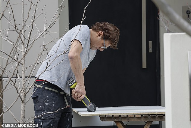 Colosimo does some maintenance work outside the Caulfield North property