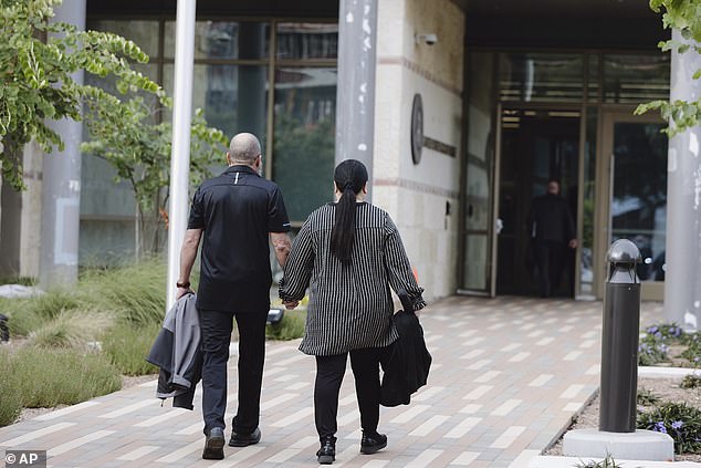 Prosecutors said Mello used the fake organization she created to apply for grants through the military program. (Pictured: Mello with her husband outside the courthouse)