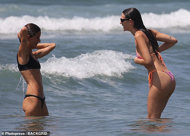 She looked in great spirits as she enjoyed a dip in the sea with her friend.