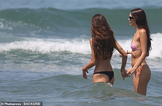 Before getting wet, her long brunette tresses were worn in loose waves over her shoulders.