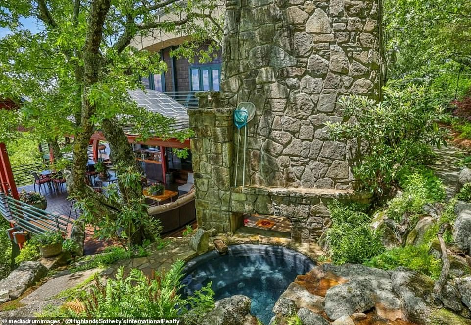 A waterfall leads into a small pond in the grounds of the stunning four-bedroom property.