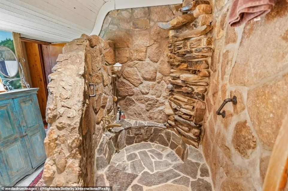 One of the six bathrooms features a stunning piece de resistance in the form of a natural stone shower.