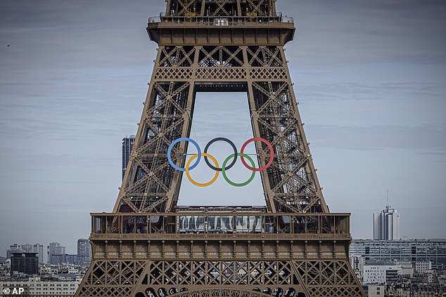 The Olympic rings are seen at the Eiffel Tower, Sunday, July 14, 2024, in Paris.