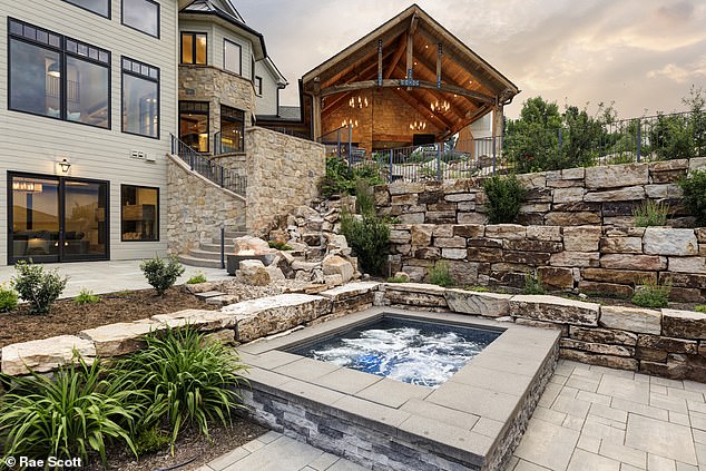 Spectacular outdoor amenities include a pool with a slide and not one, but two in-ground hot tubs to relax in after a long day.