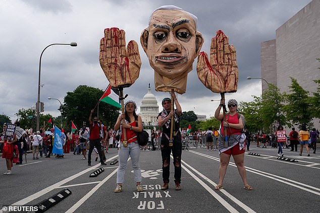 Pro-Palestinian protesters carry a depiction of Israeli Prime Minister Benjamin Netanyahu during a protest on the day of Netanyahu's speech