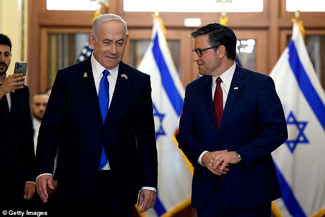 Israeli Prime Minister Benjamin Netanyahu (L) and U.S. House Speaker Mike Johnson (R-La.) walk together before a meeting at the U.S. Capitol.