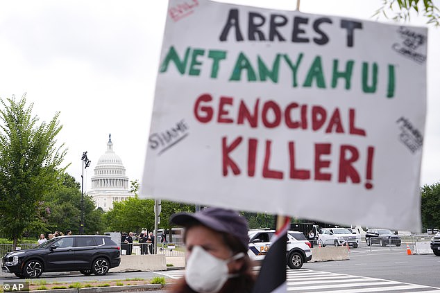 A protester carries a sign in front of the U.S. Capitol on Wednesday.