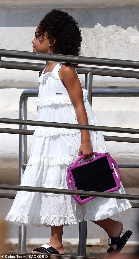 Stormi wore a tiered summer dress with ruffle detailing, and added black sandals.