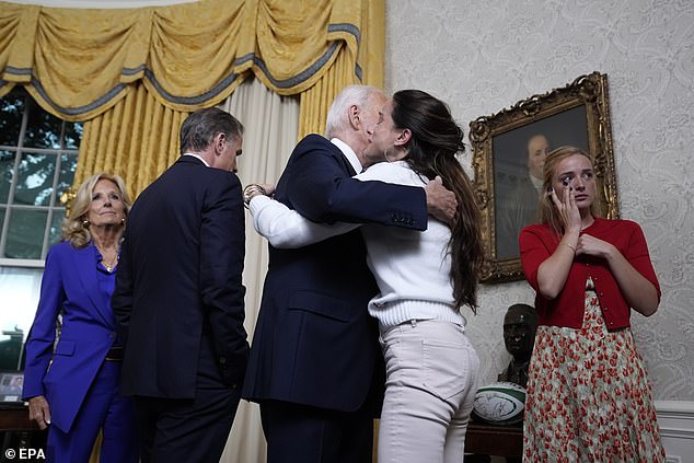 Ashley Biden hugs her father Joe Biden as Finnegan Biden wipes away tears