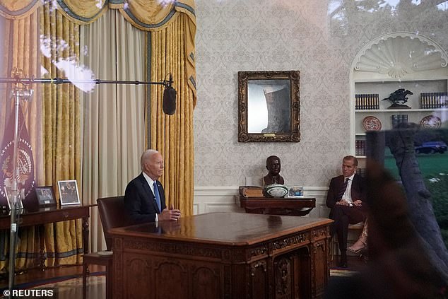 U.S. President Joe Biden addresses the nation on his decision to end his re-election campaign, from the Oval Office of the White House, as his son Hunter Biden listens, in Washington, DC.