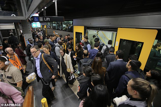 Just three months ago, the Prime Minister promised that Australia's net influx of migrants would fall to just 250,000 by 2024-25 (pictured, Sydney train passengers at City Hall).