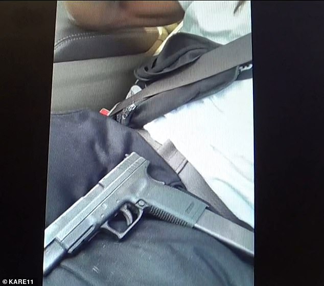 Another view of the gun on Smith's lap in the car during the video.