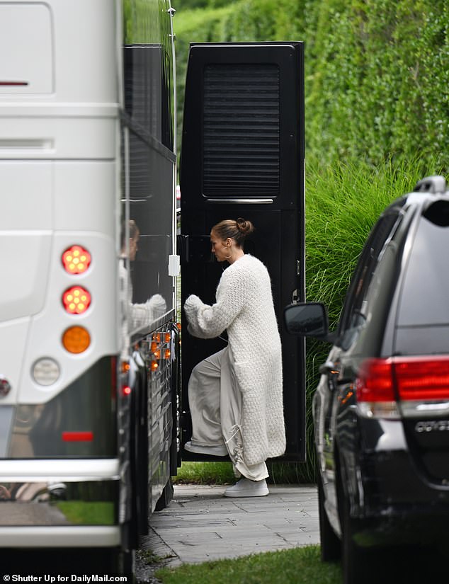 The singer wore a cozy cardigan, overalls and sneakers, with her locks pulled back into a sleek updo.