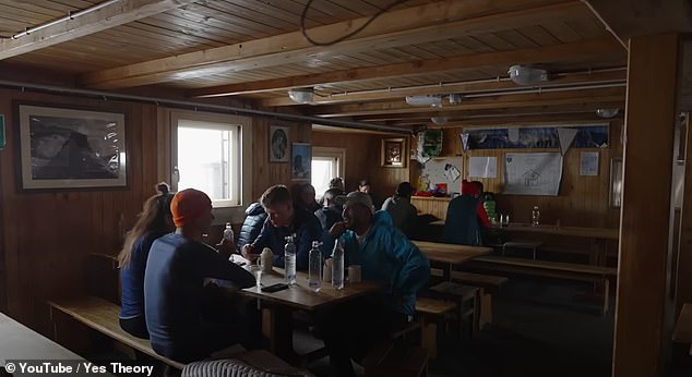 They quickly head inside the cabin to get out of the bad weather and enjoy some of the cabin's famous pizza.