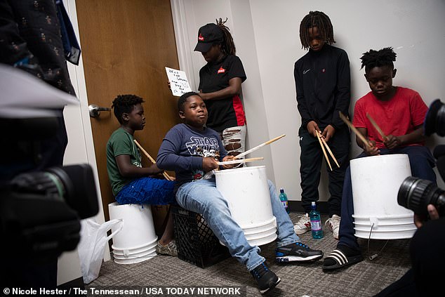 Detonio Wilson, 10, is seen here playing buckets alongside other young boys who were abused by the group.