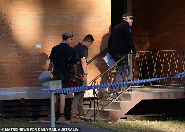 Plumbers are seen being escorted onto the property.