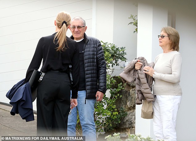 A detective is seen speaking to residents on George Street on Thursday afternoon.