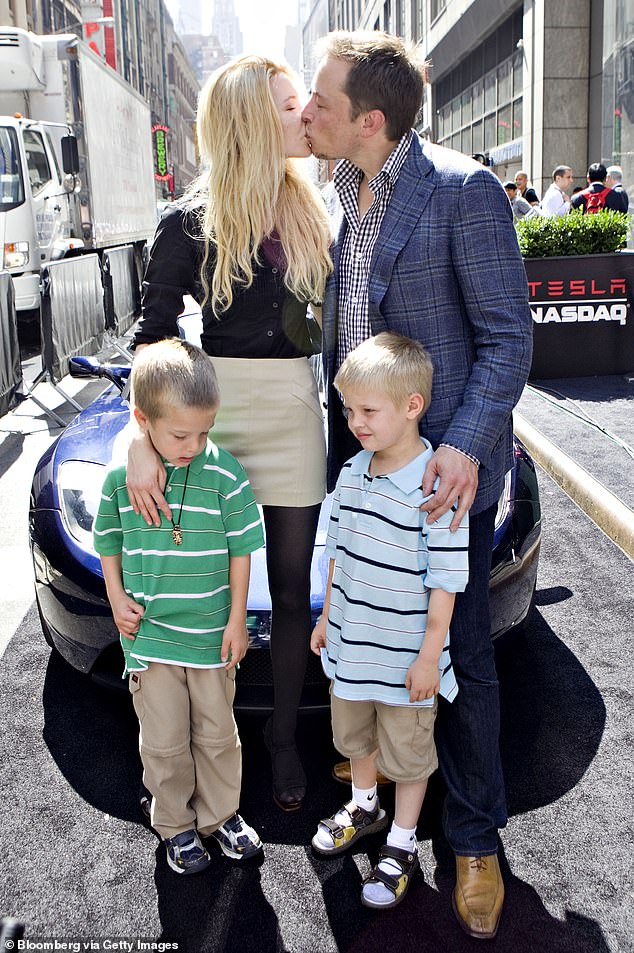 Musk kisses his then-fiancée Talulah Riley as they stand with Musk's twin sons, Griffin, left, and Xavier, now known as Vivian.