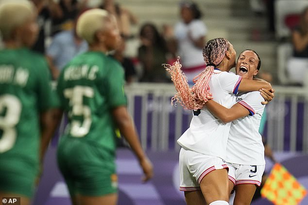 Rodman, second from right, reacts with teammate Mallory Swanson, right, after scoring.