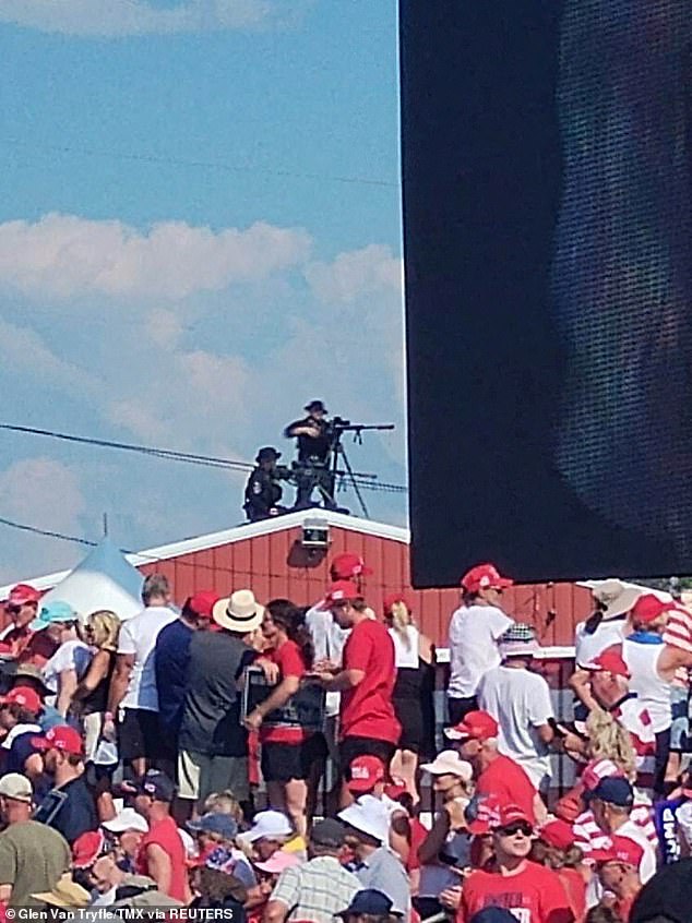 Snipers stand on a rooftop during a campaign rally for Republican presidential candidate and former US President Donald Trump