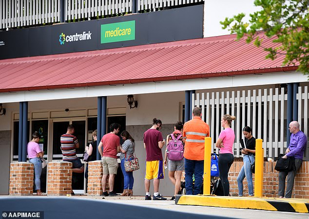 People receiving Centrelink benefits who are travelling abroad have been warned to inform the government of their plans. Pictured is a queue at a Centrelink office